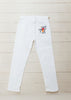 These white jeans are hand-embroidered by a group of talented makers in Guatemala using traditional techniques. The back of the jeans features a colorful embroidered floral design. 